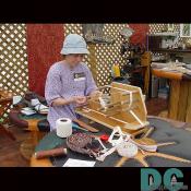 A beltmaker weaves elaborate and unique belts.