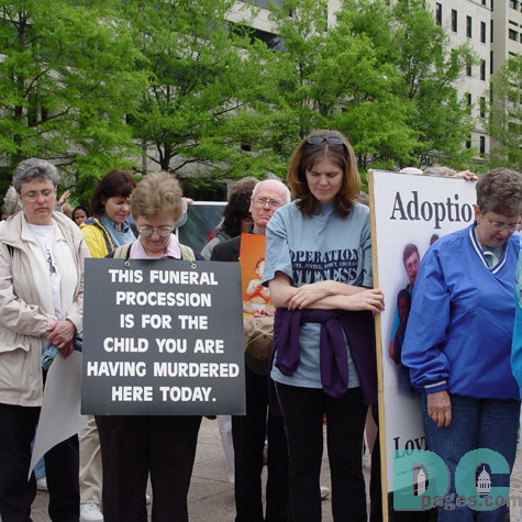 Bowing in Silence. This Funeral Procession is for the child you are having murdered here today.