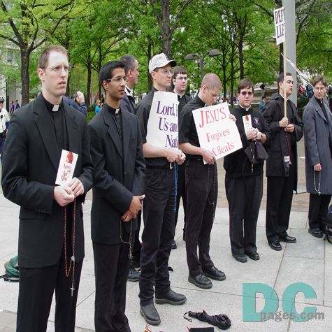 A line of Catholic priests display their faith.