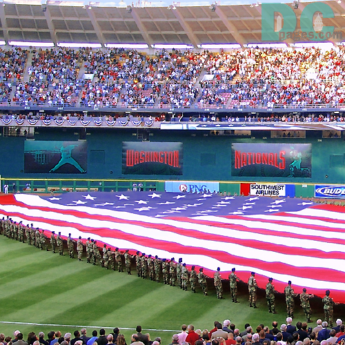 Washington Nationals' Inaugural Home Opener - Members of the District National Guard unfurl a huge Flag for the National Anthem.
