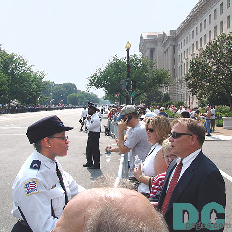 Processional watchers are greeted by the increased security along the motorcade route.