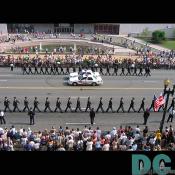 Soldiers marching in perfect formation down the street.