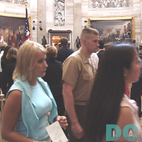 Men and women come to pay their last respects.