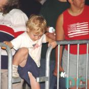 A young boy tries to get ahead in the long line.