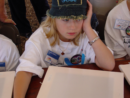 ICAF young artist and her blank canvas panel for the George Rodrigue Art for Peace Pyramid, September 11, 2003