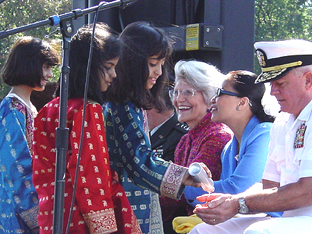Kuwaiti Children Performers bring water to Admiral Moore, September 11, 2003
