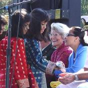 Kuwaiti Children Performers bring water to Admiral Moore, September 11, 2003