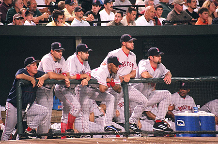 The Red Sox dugout looks on to see if the ball will be a foul or fair play.