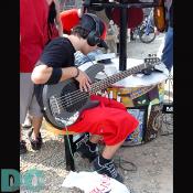 A boy checks out the hottest new guitar models at a kiosk.