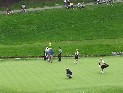 Down at the hole, watching this Pro plan his shot
