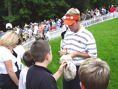 Happy to meet his fans, this Pro signs autographs