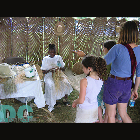Young lady showing her basketry talent.