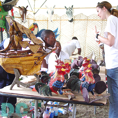 A woman is intrigued by the rooster.