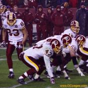 Redskins Quarterback, Todd Collins, looks down his offensive line to see if his team is ready.