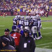 Dallas Cowboy players huddle together after being humiliated.