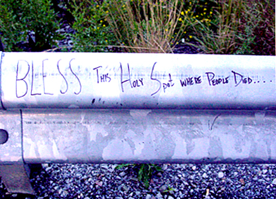 Bless this holy spot where people died written on guard rail.
