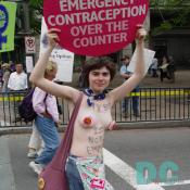 A marcher bares a lot to get across her point: EMERGENCY CONTRACEPTION OVER THE COUNTER.