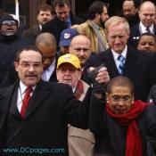 DC Council Chair Vincent C. Gray and Congresswoman Eleanor Holmes Norton raise their hands together in solidarity.