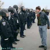 Protestor standing up to law enforcement officials in a face-off.