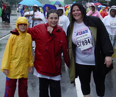 Even soaking wet, a mother and her two sons pose with smiles after finishing the race.