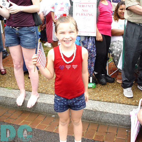 Despite the heavy downpours, tourists like this little girl didn't mind getting a little drenched to see the festivities.