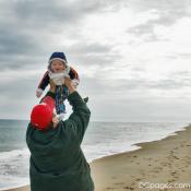Luke holding up Jr. at Sandbridge Beach