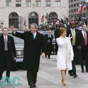Emerging from their armored limousine, President George W. Bush and first lady Laura Bush wave to well wishers as they prepare to travel 1.7-miles along the inaugural parade route.