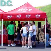 Locally based radio station, HOT 99.5 passes out hand fans and other souveneirs.