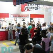 People waiting in line during half time to refill their favorite soccer game snacks.