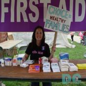 First Aid Tent located on the National Mall. Pro-Choice activist was giving away condoms, literature, and holds up a Pro-Choice Demonstration Sign - CHOICE = HEALTHY FAMILIES - 