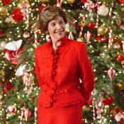 First Lady, Laura Bush, poses in front of the White House Christmas Tree.
