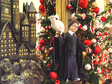 Harry Potter poses in front of Hogwarts, which was made out of gingerbread.