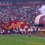 Cannons thunder as the Redskins color guard runs out into Fedex stadium.