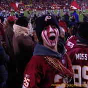 This Redskin fan is decked out in warpaint and party beads.