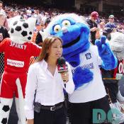 An attractive ABC SPORTS reporter was talking about the match with Earth Quakes' mascot, Rikter.  