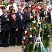 Senator John Warner, and other Americans place their hand over their hearts while Taps plays at the Tomb of the Unknowns during Memorial Day ceremonies, May 29, 2006 at Arlington National Cemetery.
